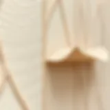 A close-up view of textured wallpaper being peeled off a wall