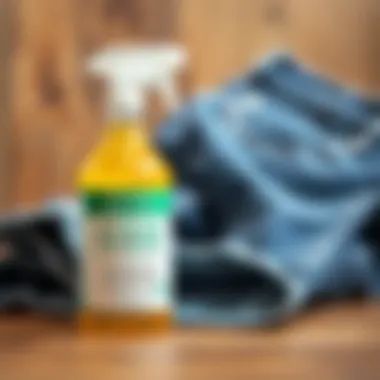 A bottle of chemical stain remover next to a pair of jeans
